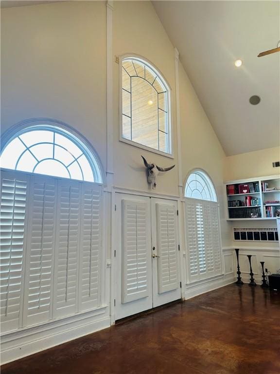 foyer entrance featuring high vaulted ceiling and ceiling fan