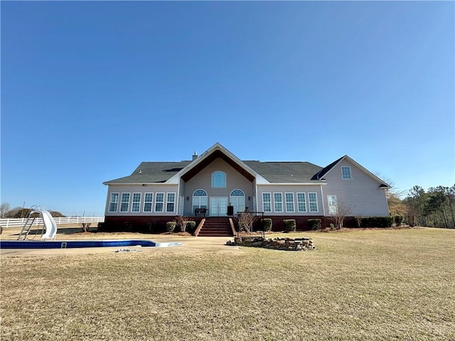 rear view of house with a yard