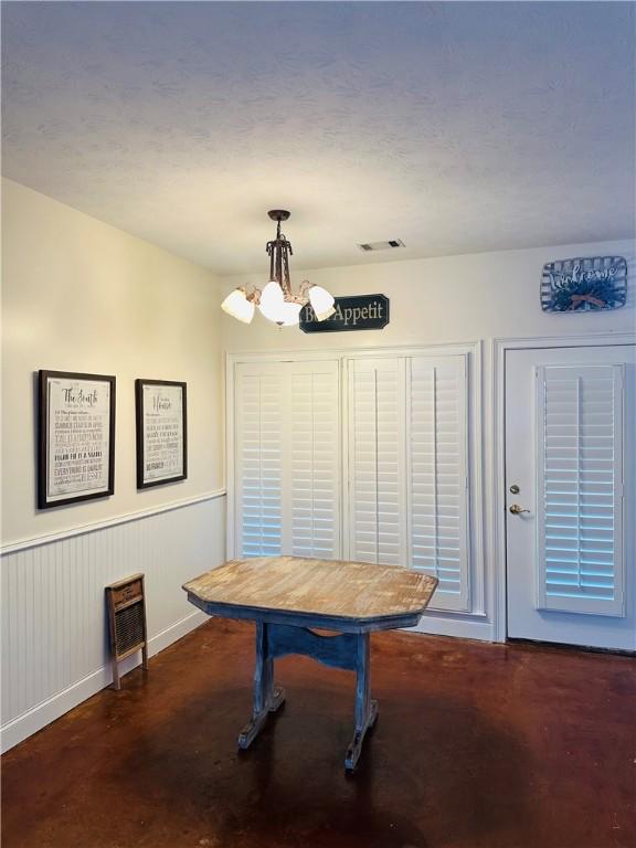 dining space featuring a chandelier