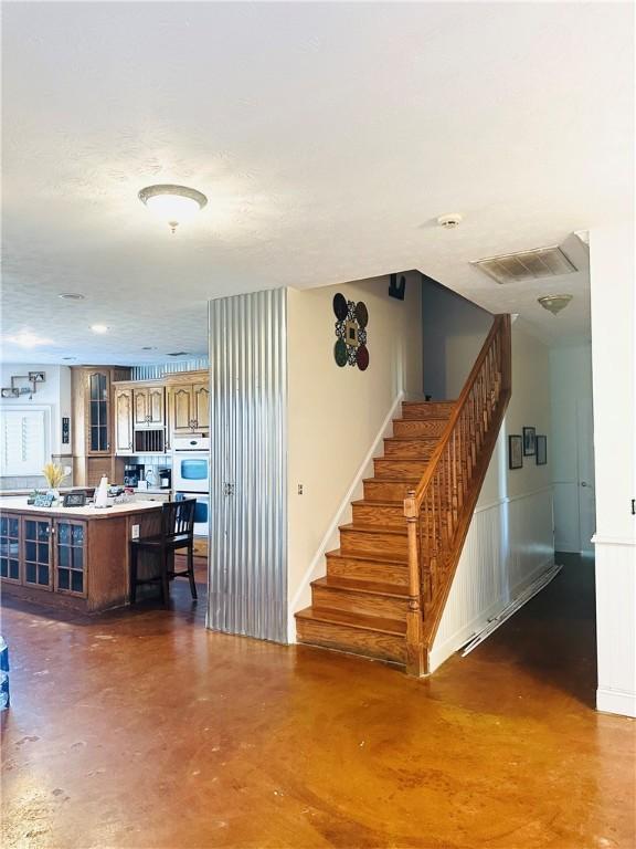 staircase with concrete floors