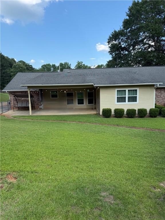 1202 Northgate Dr, Opelika, AL 36801 - rear view of house featuring a patio and a lawn