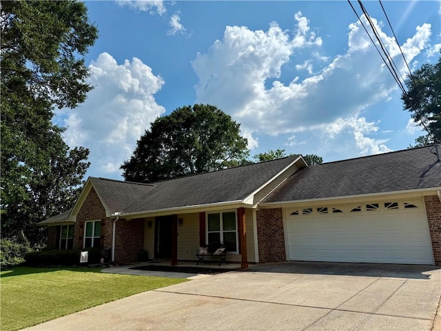 1202 Northgate Dr, Opelika, AL 36801 - ranch-style house with brick siding, concrete driveway, a garage, and a front lawn