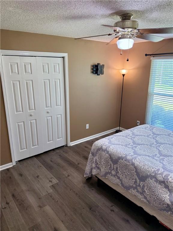 1202 Northgate Dr, Opelika, AL 36801 - bedroom with a textured ceiling, dark wood finished floors, ceiling fan, and a closet