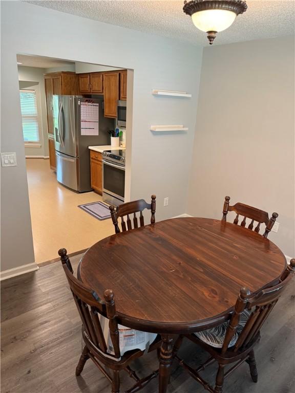1202 Northgate Dr, Opelika, AL 36801 - dining area with light wood finished floors and a textured ceiling
