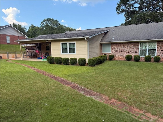 1202 Northgate Dr, Opelika, AL 36801 - view of front facade featuring a patio area, a shingled roof, and brick siding