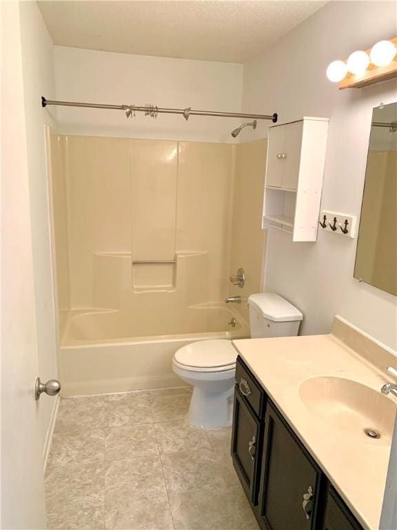 bathroom featuring tile patterned flooring, shower / washtub combination, toilet, and vanity