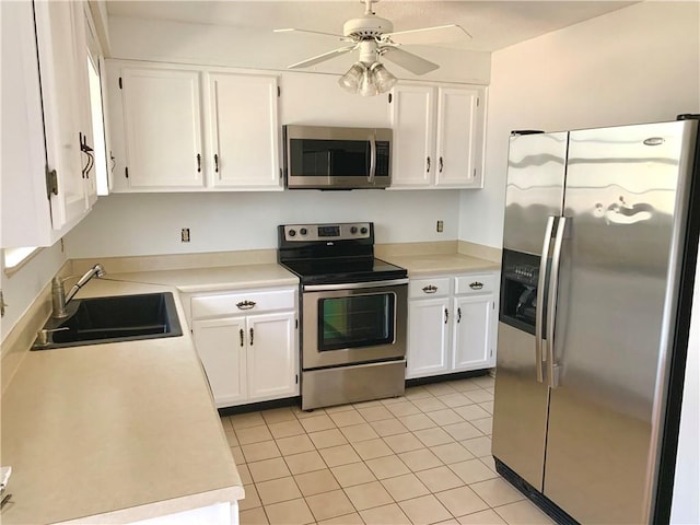 kitchen with white cabinetry, light countertops, appliances with stainless steel finishes, and a sink