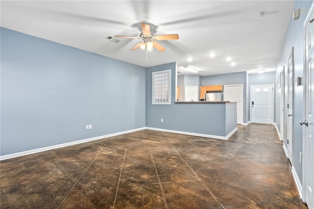 unfurnished living room featuring baseboards, visible vents, and ceiling fan