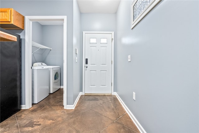 laundry room featuring washer and dryer, baseboards, and laundry area