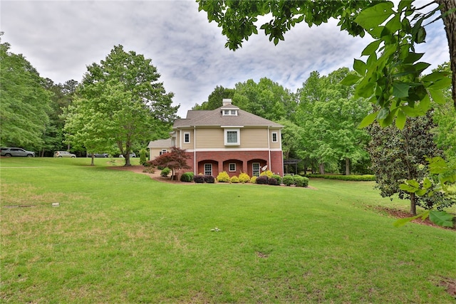 view of front of home featuring a front yard and brick siding
