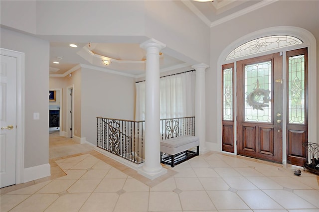 entrance foyer with ornate columns, ornamental molding, baseboards, tile patterned floors, and recessed lighting