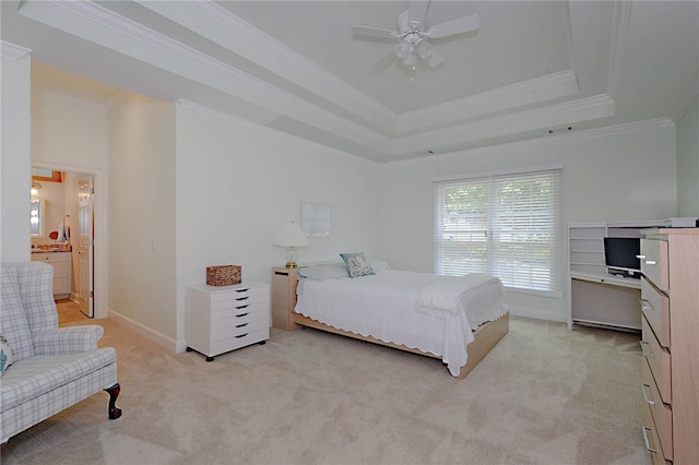 bedroom featuring light carpet, crown molding, a tray ceiling, baseboards, and ceiling fan