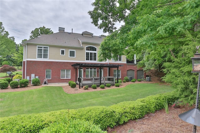 rear view of house featuring a pergola, brick siding, a lawn, central AC, and a chimney