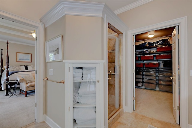 corridor with light colored carpet and crown molding