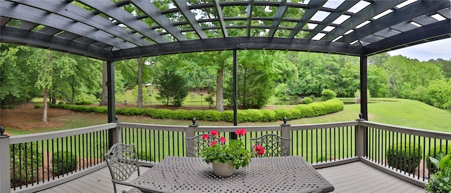 deck featuring a pergola, outdoor dining space, and a lawn