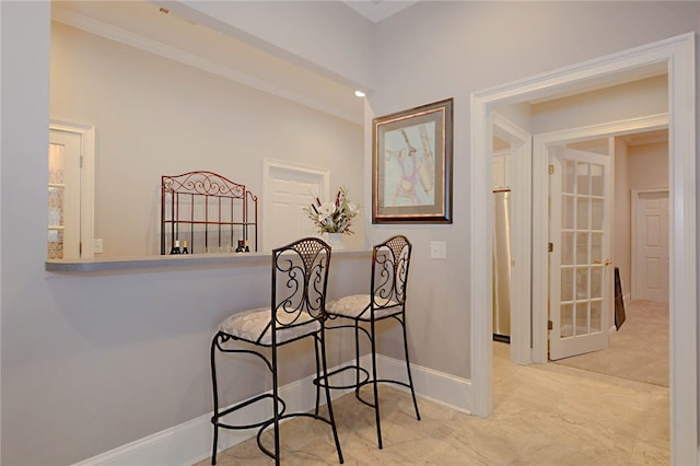 hallway featuring baseboards and crown molding