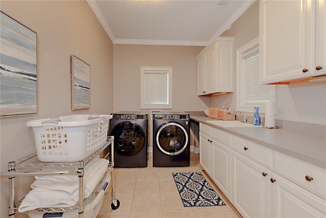 laundry area with cabinet space, independent washer and dryer, ornamental molding, and light tile patterned floors