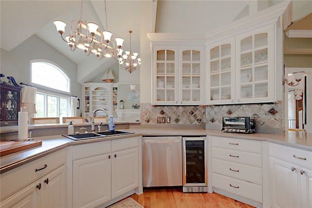 kitchen featuring stainless steel dishwasher, wine cooler, a sink, tasteful backsplash, and high vaulted ceiling