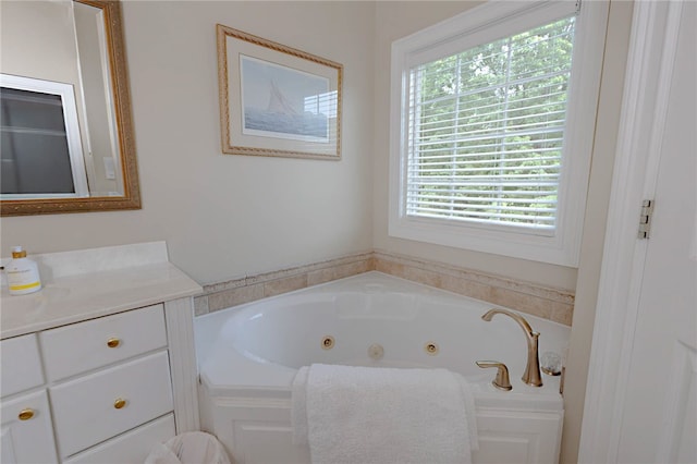 full bath with a whirlpool tub and vanity