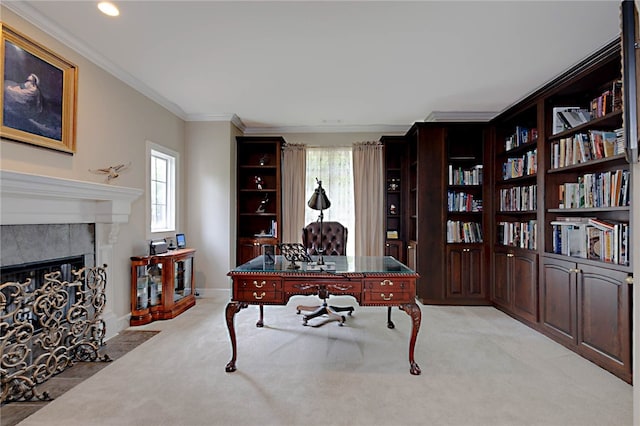 office space featuring plenty of natural light, ornamental molding, light colored carpet, a tiled fireplace, and baseboards