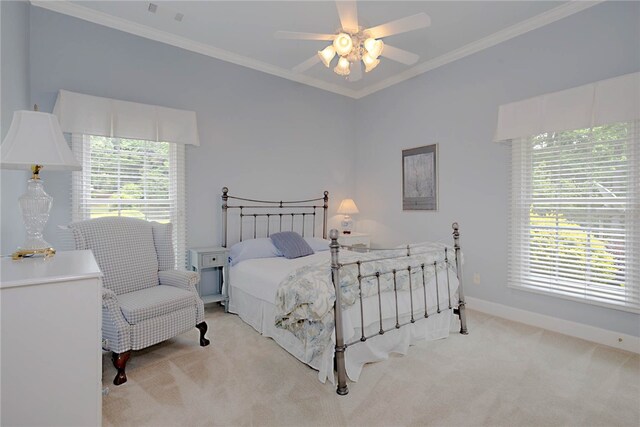 bedroom featuring light carpet, ornamental molding, baseboards, and a ceiling fan