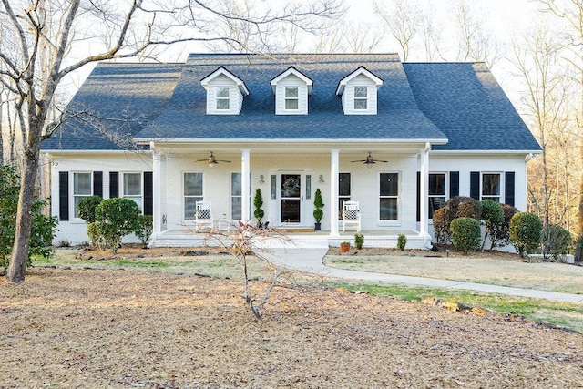 new england style home with covered porch and ceiling fan