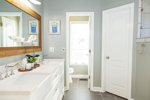 bathroom featuring vanity, tile patterned floors, and toilet