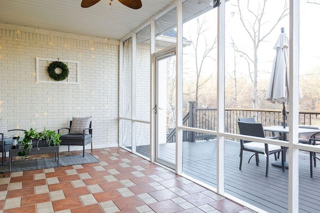 sunroom / solarium featuring ceiling fan