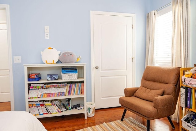 sitting room with wood-type flooring