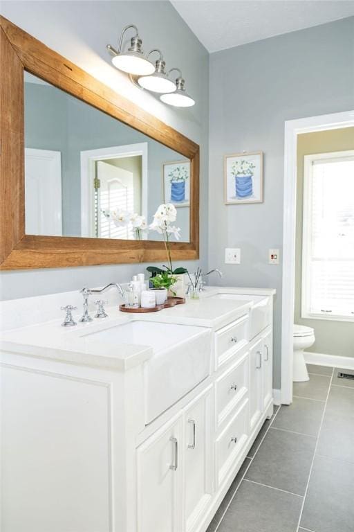 bathroom featuring vanity, toilet, and tile patterned flooring