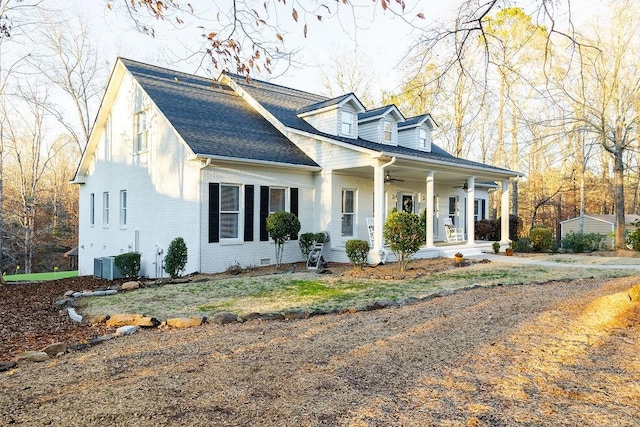 cape cod house with central air condition unit and covered porch