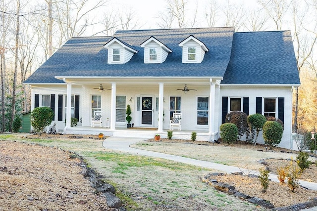 cape cod home featuring ceiling fan and a porch