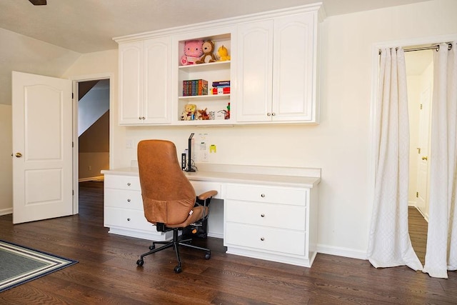 office area featuring built in desk, dark wood-type flooring, and vaulted ceiling