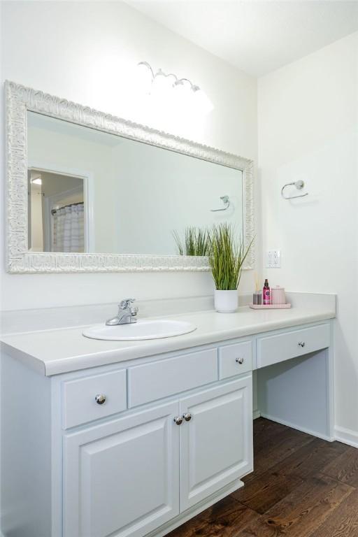 bathroom with hardwood / wood-style flooring and vanity