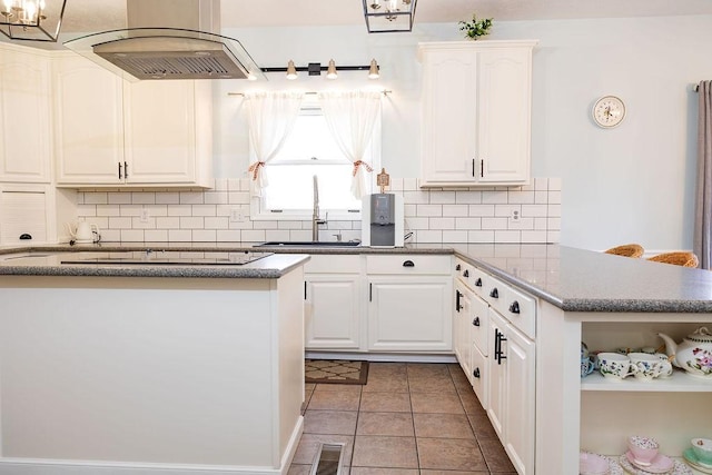 kitchen featuring white cabinetry, sink, island range hood, and light tile patterned floors