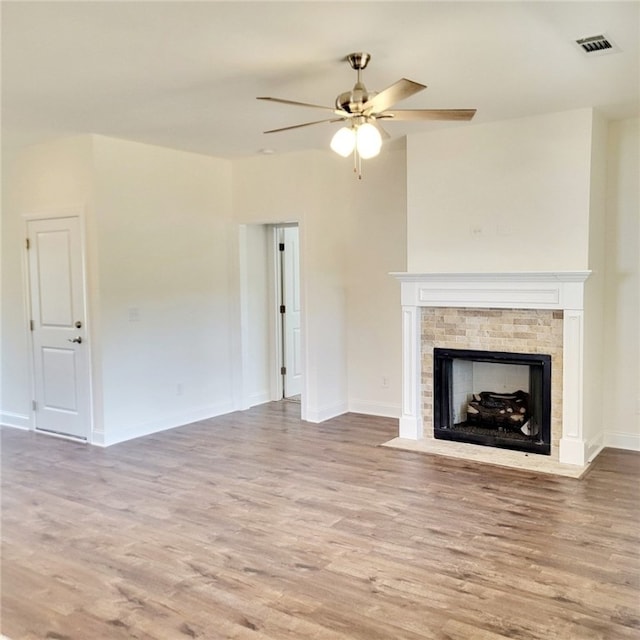705 Riverside Ests, Lanett, AL 36863 - unfurnished living room featuring a fireplace with flush hearth, wood finished floors, visible vents, and ceiling fan