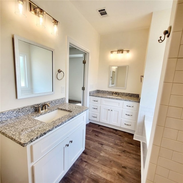 705 Riverside Ests, Lanett, AL 36863 - full bath with visible vents, wood finished floors, two vanities, and a sink