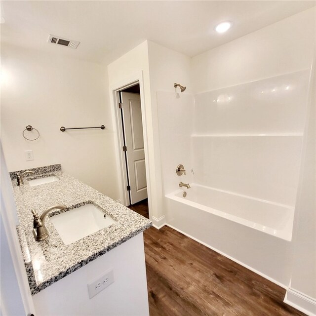 705 Riverside Ests, Lanett, AL 36863 - bathroom with double vanity, shower / washtub combination, wood finished floors, and a sink