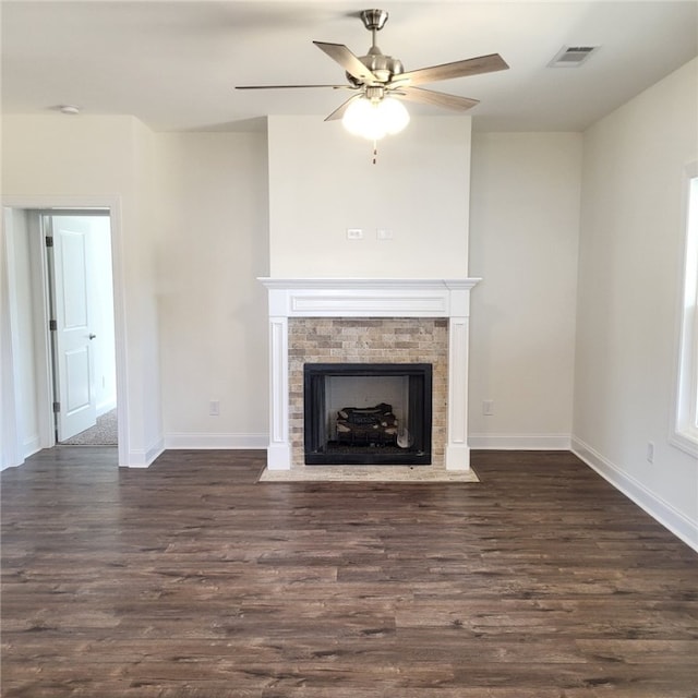 705 Riverside Ests, Lanett, AL 36863 - unfurnished living room featuring a fireplace with flush hearth, visible vents, dark wood-style flooring, and baseboards