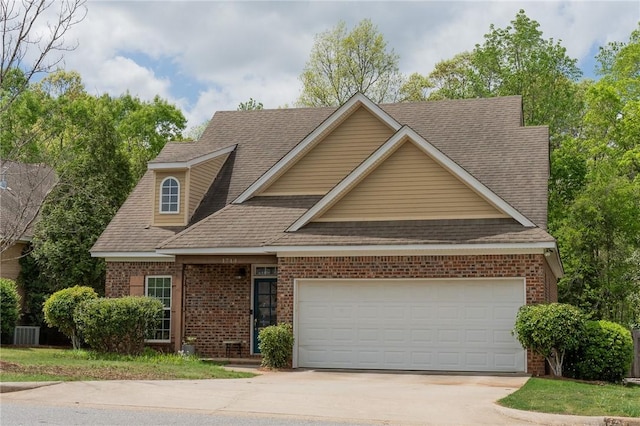 1714 Vfw Rd, Auburn, AL 36830 - view of front facade featuring driveway, brick siding, roof with shingles, and an attached garage