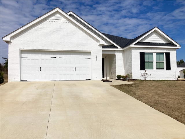 single story home featuring concrete driveway, brick siding, and an attached garage