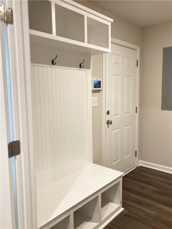 mudroom featuring dark wood-style floors, electric panel, and baseboards