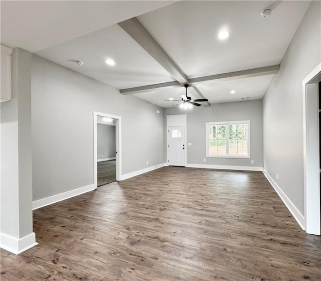 unfurnished living room with ceiling fan, dark hardwood / wood-style flooring, beamed ceiling, and coffered ceiling