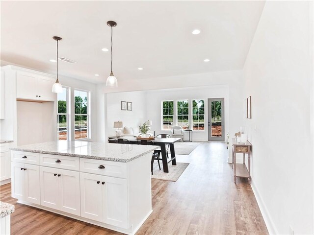 8 Crossing Ct E, Valley, AL 36854 - kitchen featuring healthy amount of natural light, light wood finished floors, open floor plan, white cabinets, and recessed lighting
