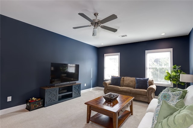 living room with light carpet and ceiling fan