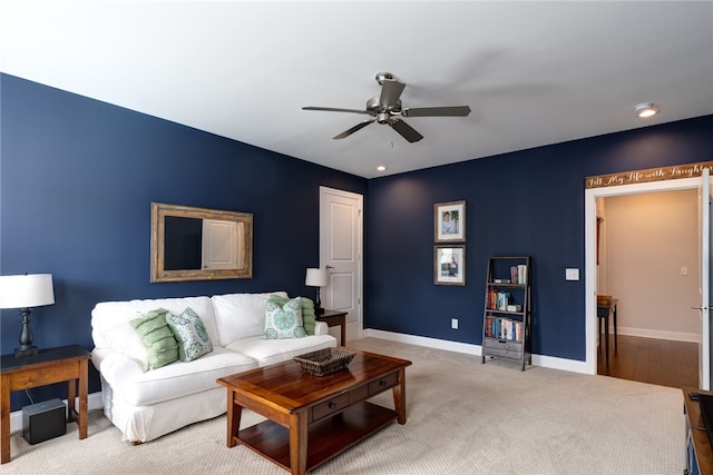 carpeted living room with ceiling fan