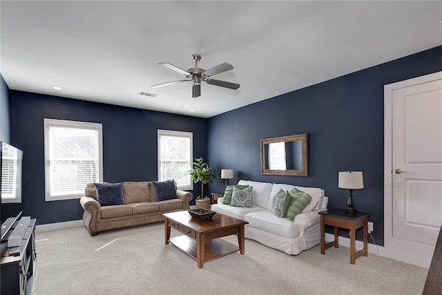 carpeted living room with ceiling fan