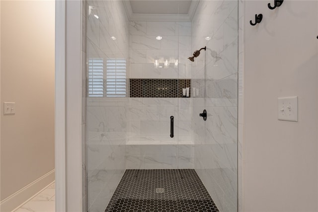 bathroom featuring a shower with shower door and crown molding