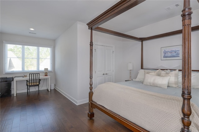 bedroom featuring dark wood-type flooring and a closet