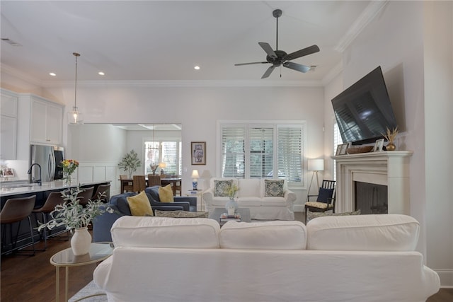 living room with dark hardwood / wood-style flooring, ornamental molding, and ceiling fan